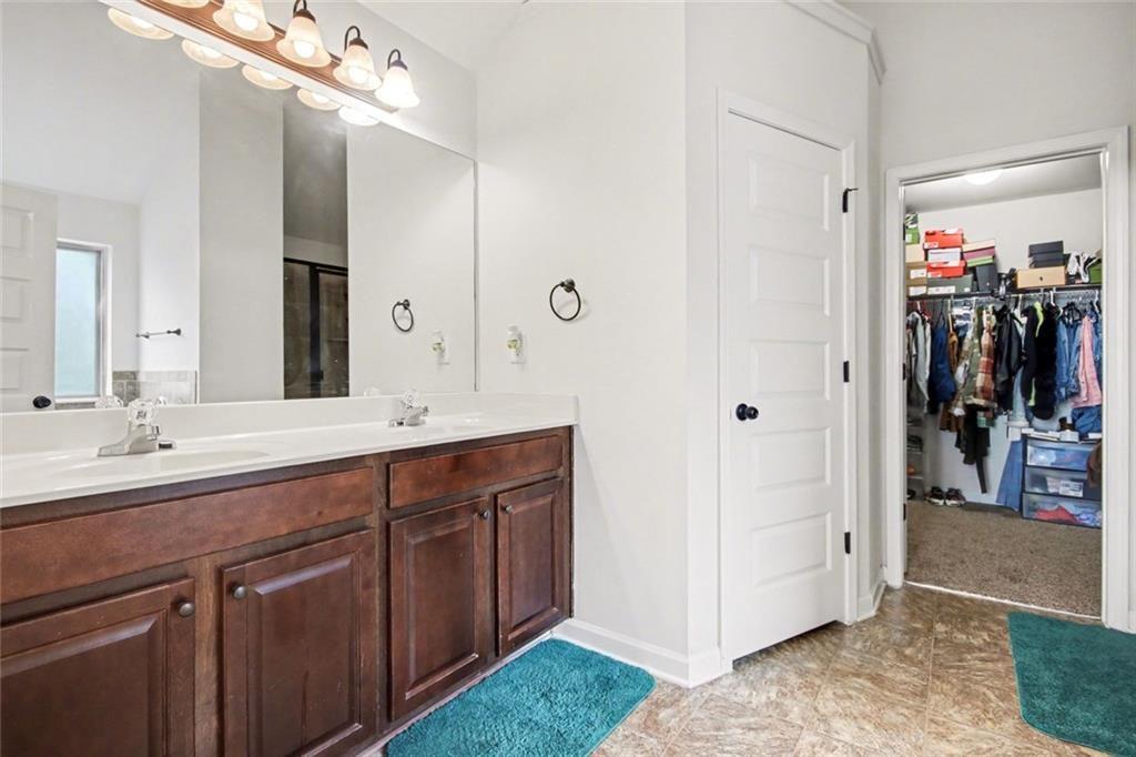 767 Effendi Place Fairburn, GA 30213 - Photo 29 of 35 a spacious bathroom with a sink and a mirror