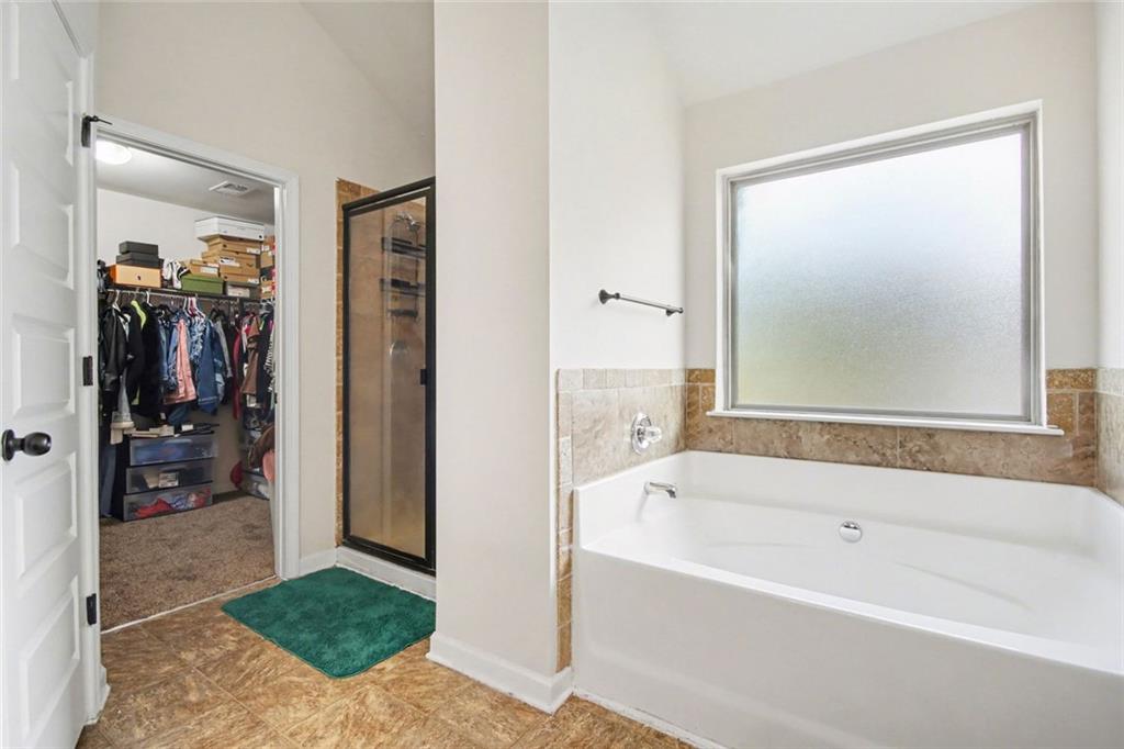 767 Effendi Place Fairburn, GA 30213 - Photo 31 of 35 a bathroom with a bathtub and a shower