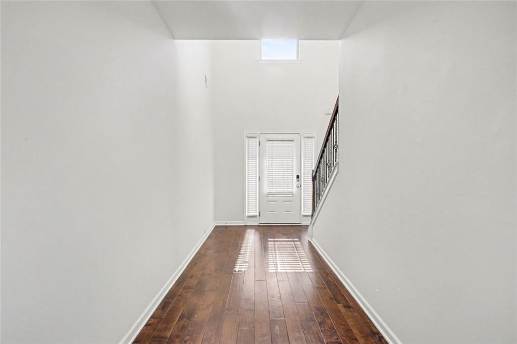767 Effendi Place Fairburn, GA 30213 - Photo 5 of 35 a view of a hallway with wooden floor and entryway
