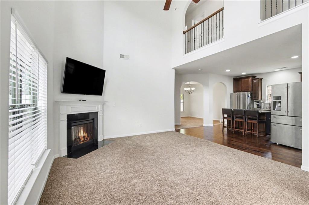 767 Effendi Place Fairburn, GA 30213 - Photo 7 of 35 a view of livingroom with kitchen and fireplace