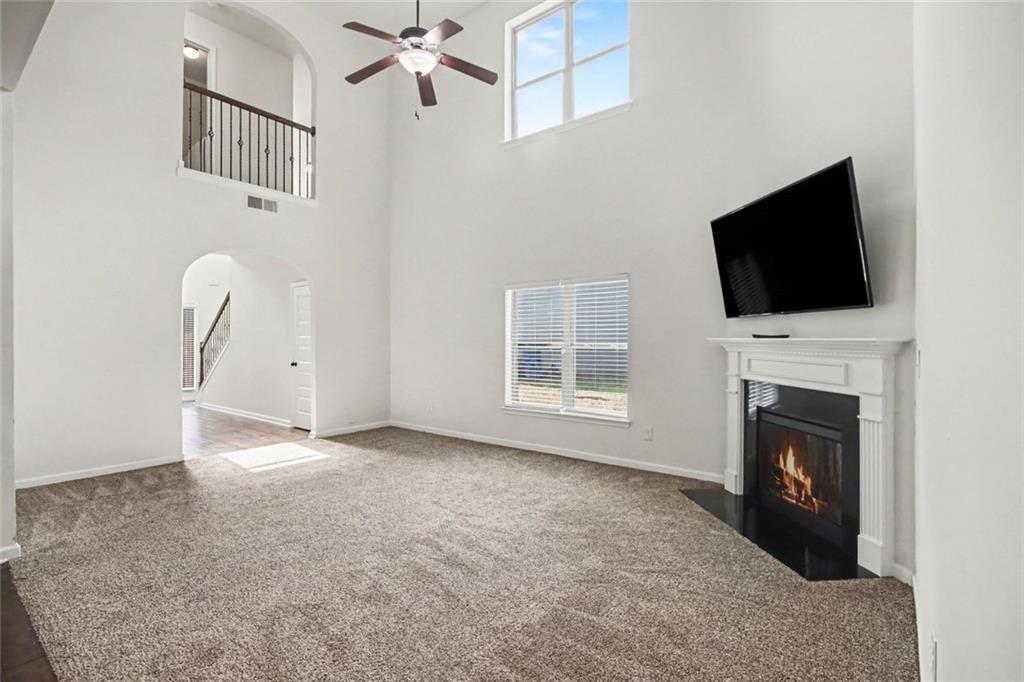767 Effendi Place Fairburn, GA 30213 - Photo 8 of 35 a view of a livingroom with an empty space and a fireplace
