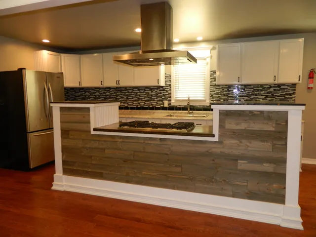 a kitchen with stainless steel appliances granite countertop a stove and a refrigerator