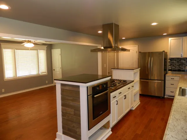 a kitchen with stainless steel appliances a stove a refrigerator and a oven