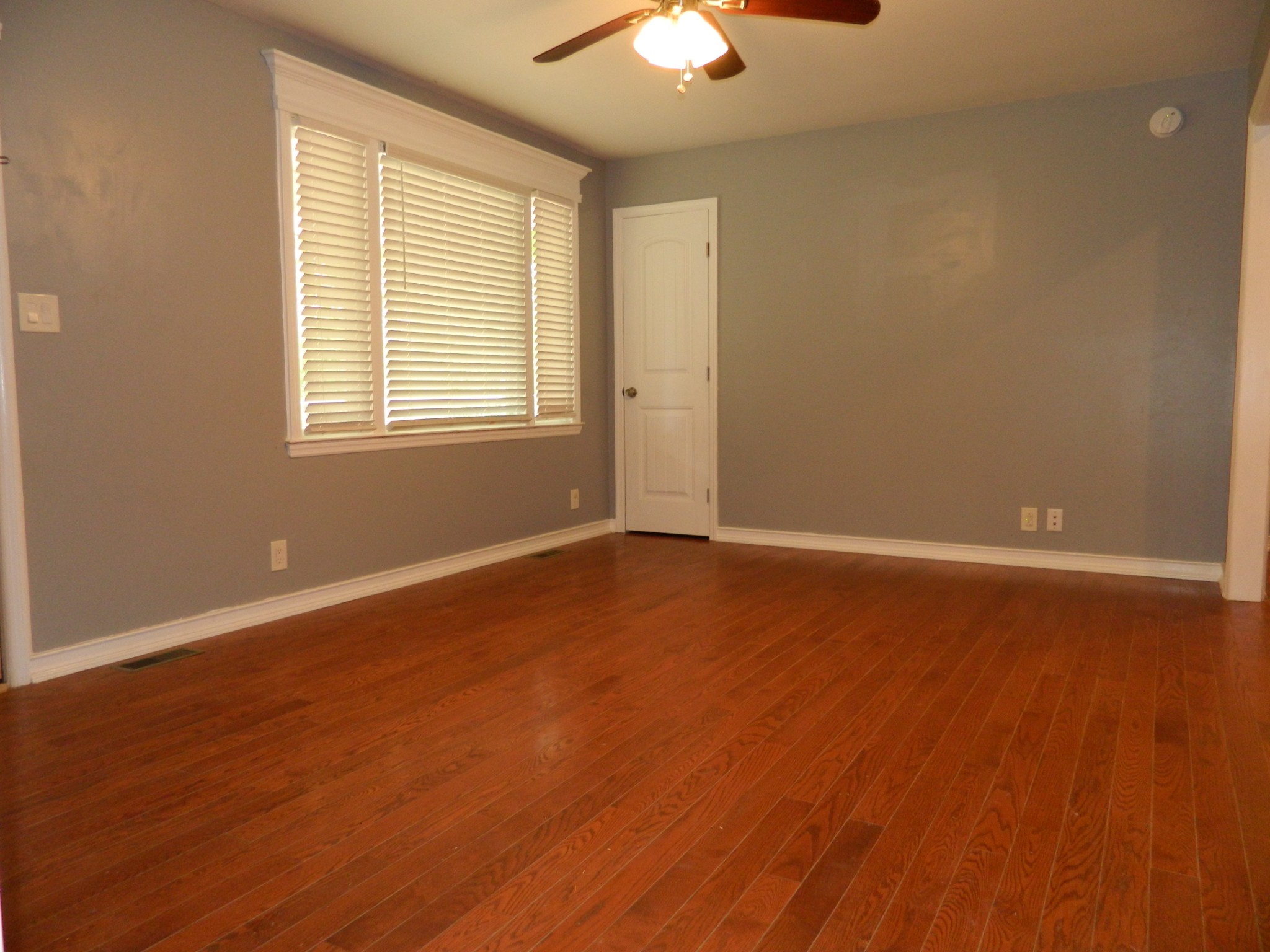 2128 Sanders Road Clarksville, TN 37043 - Photo 8 of 21 an empty room with wooden floor and windows