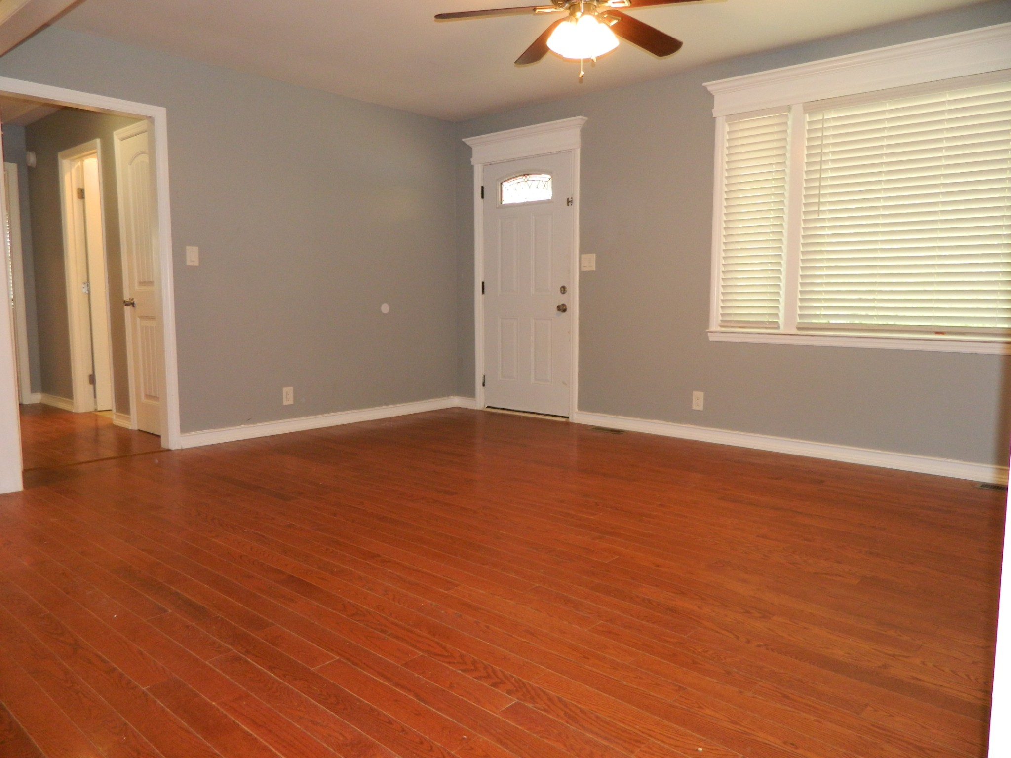 2128 Sanders Road Clarksville, TN 37043 - Photo 9 of 21 an empty room with wooden floor and windows