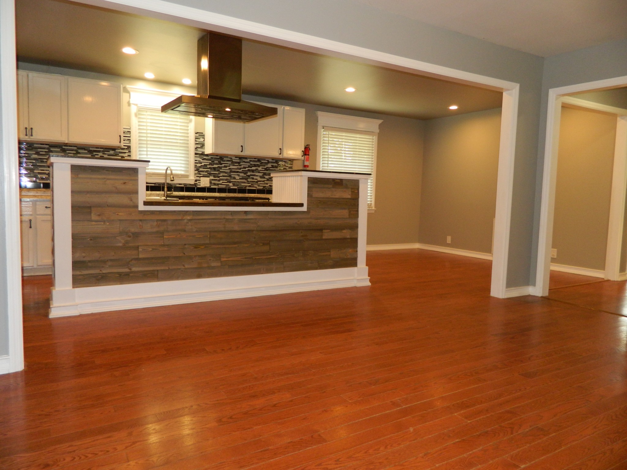 2128 Sanders Road Clarksville, TN 37043 - Photo 10 of 21 an empty room with wooden floor and kitchen view