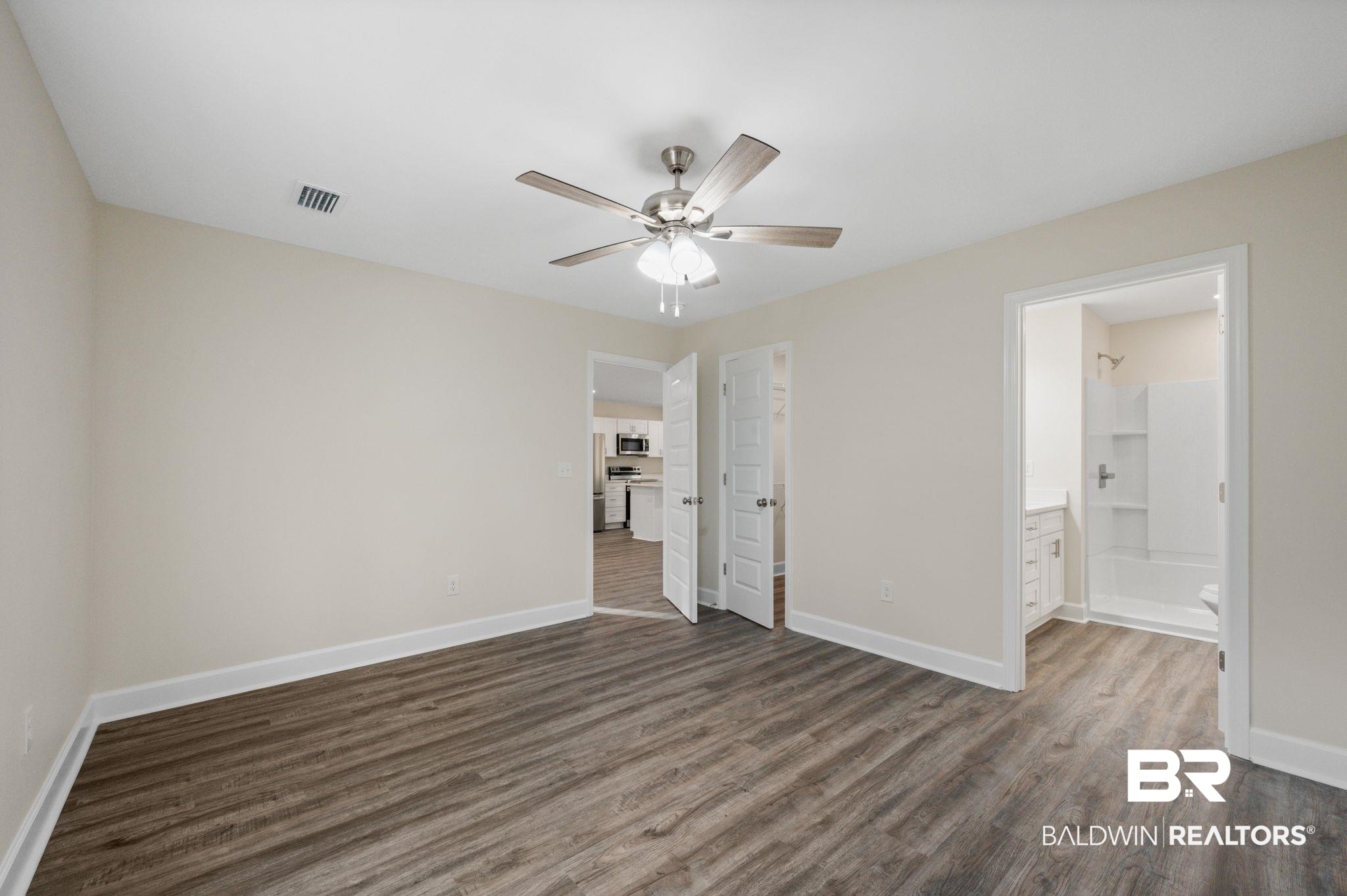 1473 Pollard Road Daphne, AL 36526 - Photo 20 of 32 Unfurnished bedroom with dark hardwood / wood-style flooring, connected bathroom, and ceiling fan