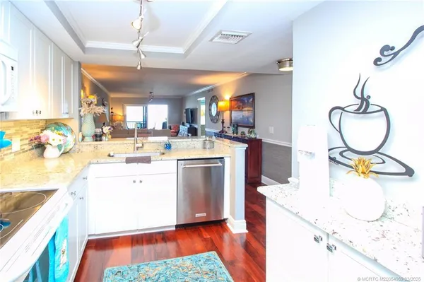 a kitchen with a sink appliances and cabinets