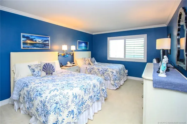 a bedroom with double bed and a window