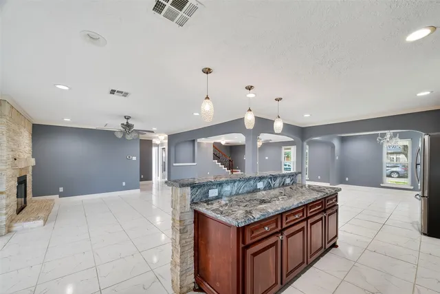 a bathroom with a granite countertop toilet sink and mirror