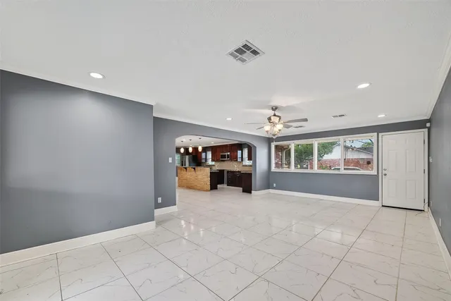 a view of a backyard with potted plants and wooden fence
