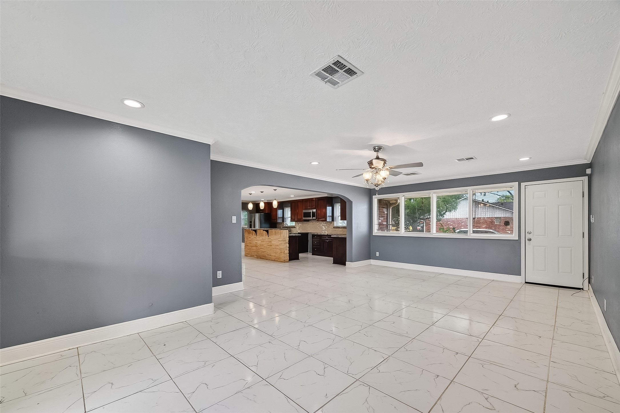 4901 Burning Tree Drive Baytown, TX 77521 - Photo 18 of 47 a view of an empty room with furniture and a kitchen