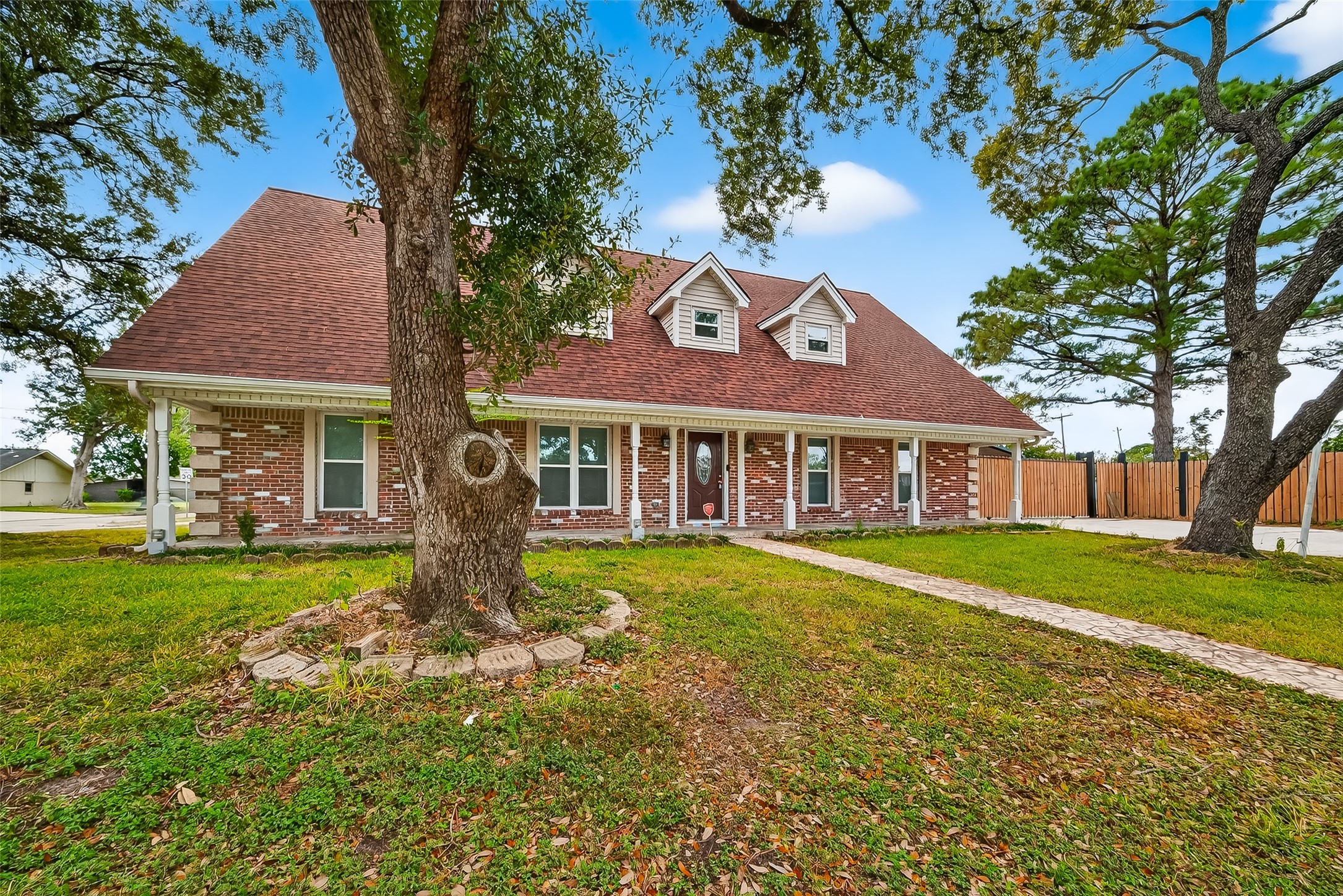 4901 Burning Tree Drive Baytown, TX 77521 - Photo 2 of 47 a front view of a house with garden