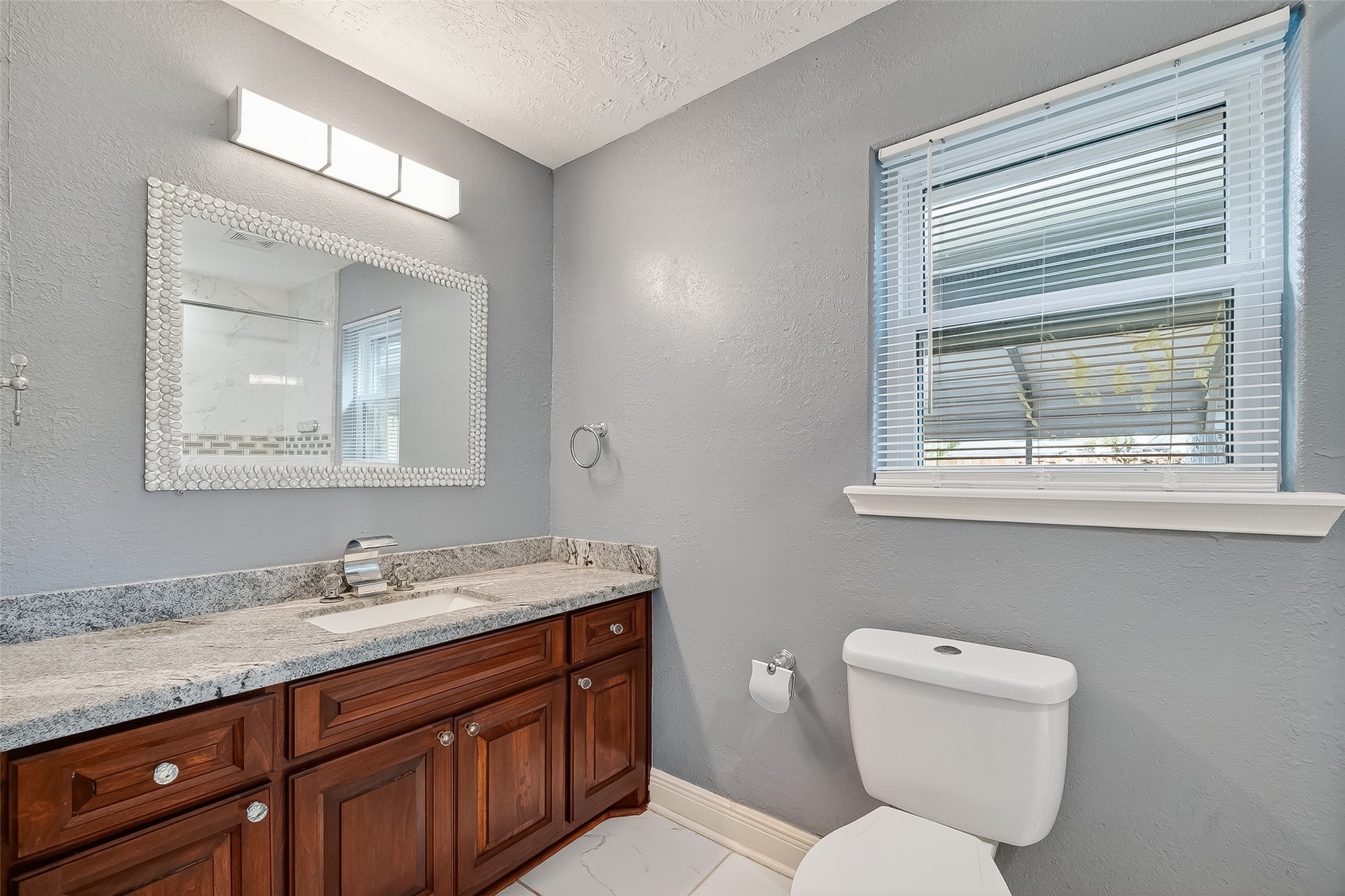 4901 Burning Tree Drive Baytown, TX 77521 - Photo 27 of 47 a bathroom with a granite countertop toilet sink and mirror