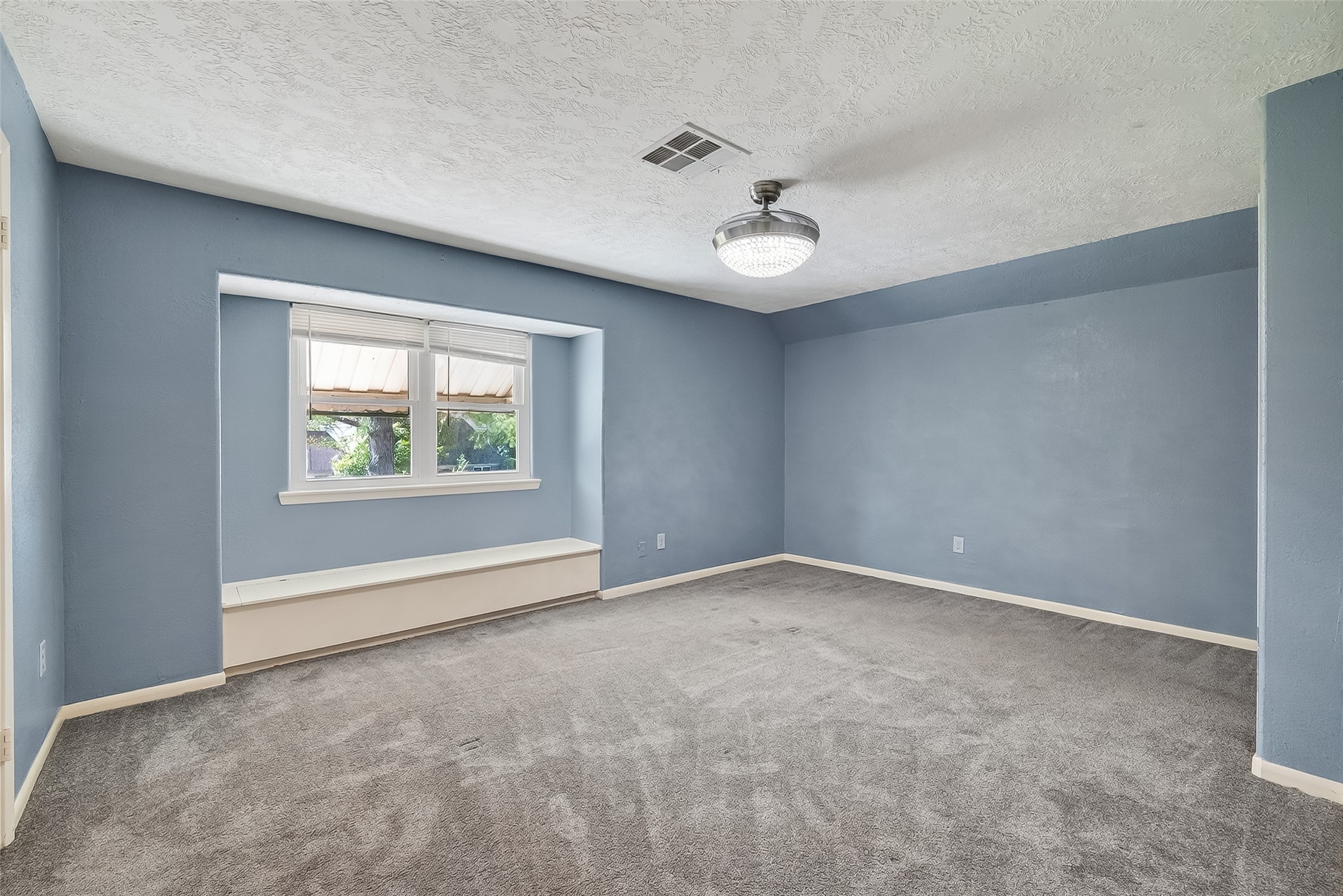 4901 Burning Tree Drive Baytown, TX 77521 - Photo 31 of 47 an empty room with windows and ceiling fan