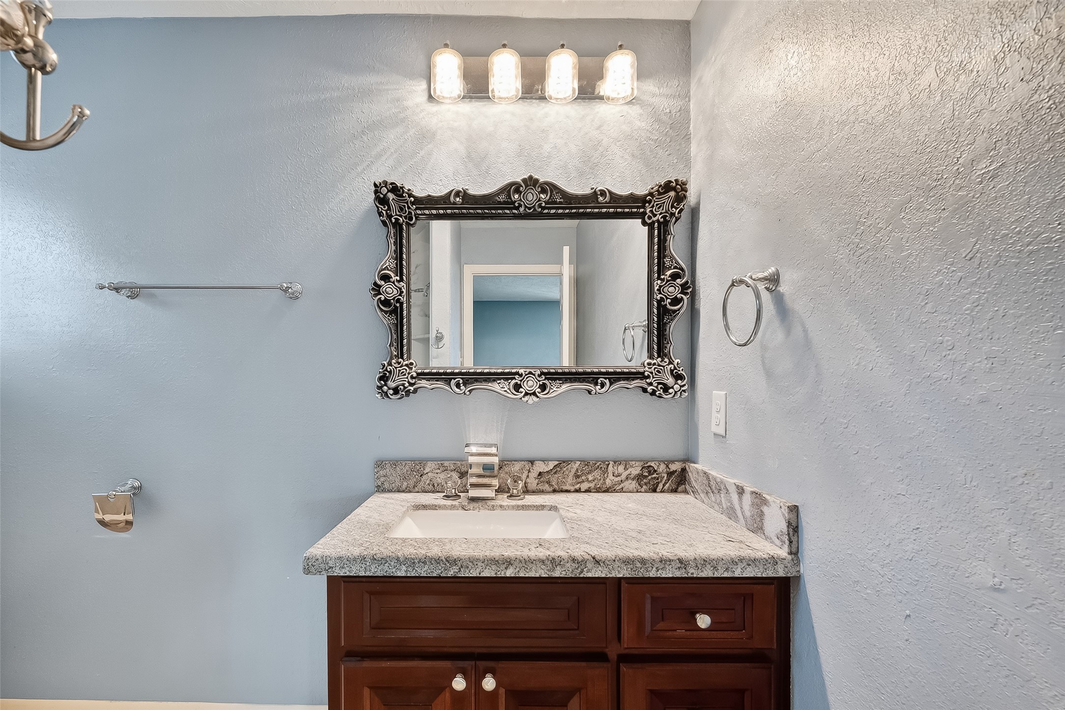 4901 Burning Tree Drive Baytown, TX 77521 - Photo 33 of 47 a bathroom with a granite countertop sink and a mirror