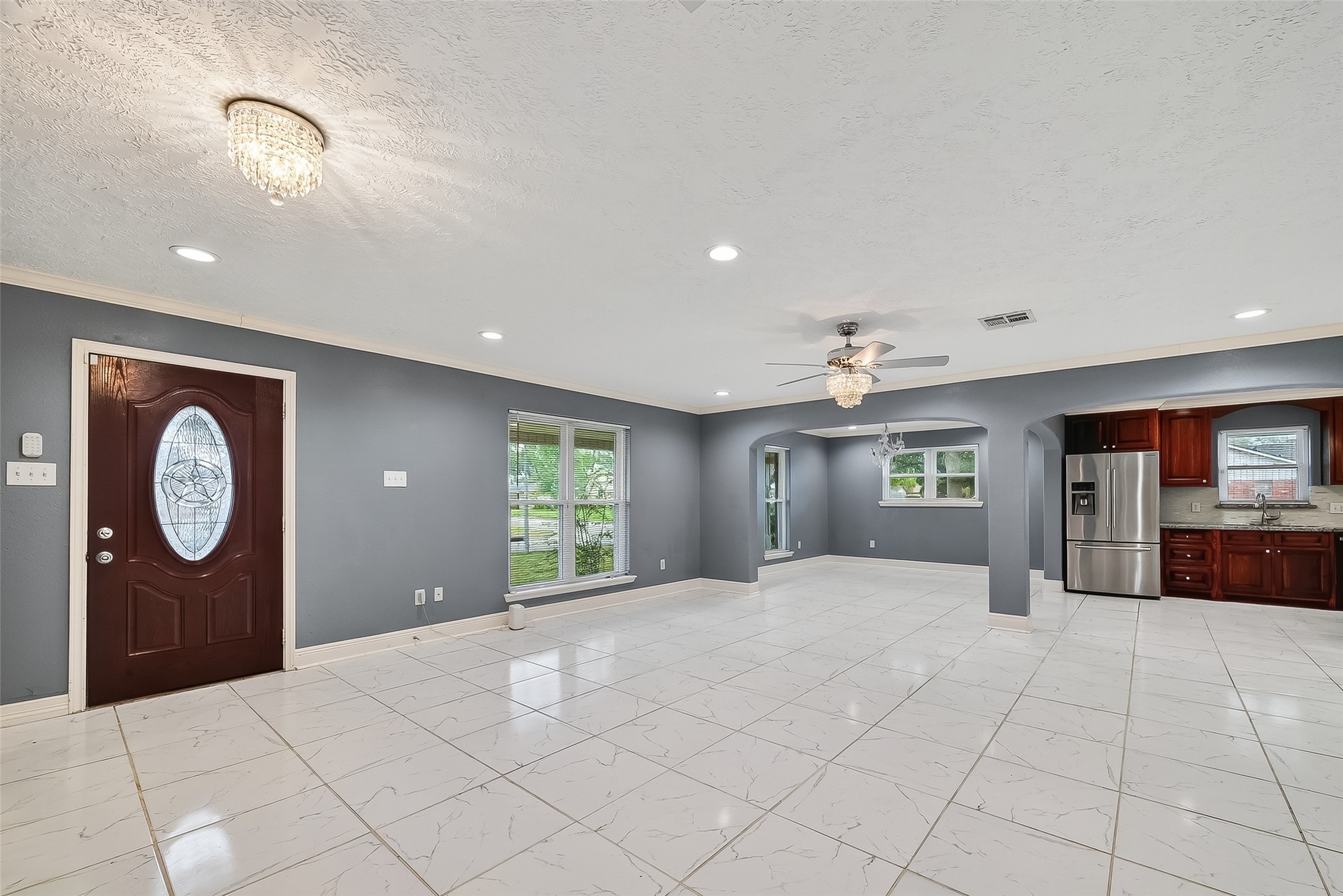 4901 Burning Tree Drive Baytown, TX 77521 - Photo 4 of 47 a large bedroom with a large bed and a chandelier