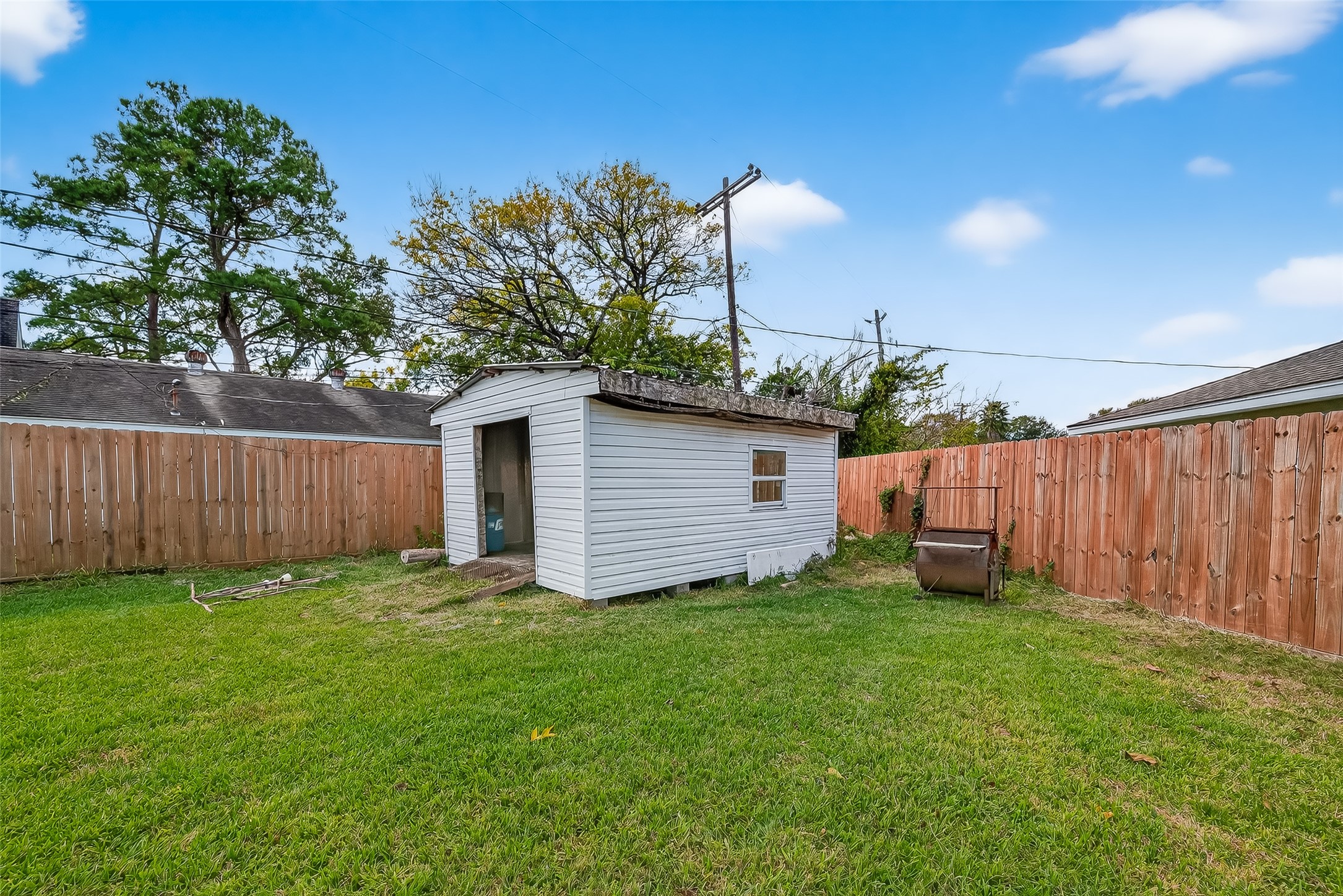 4901 Burning Tree Drive Baytown, TX 77521 - Photo 44 of 47 a view of a backyard with potted plants and wooden fence