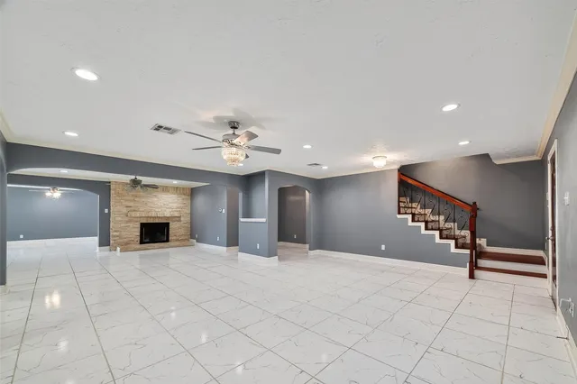 a large kitchen with stainless steel appliances granite countertop a refrigerator a oven and a sink