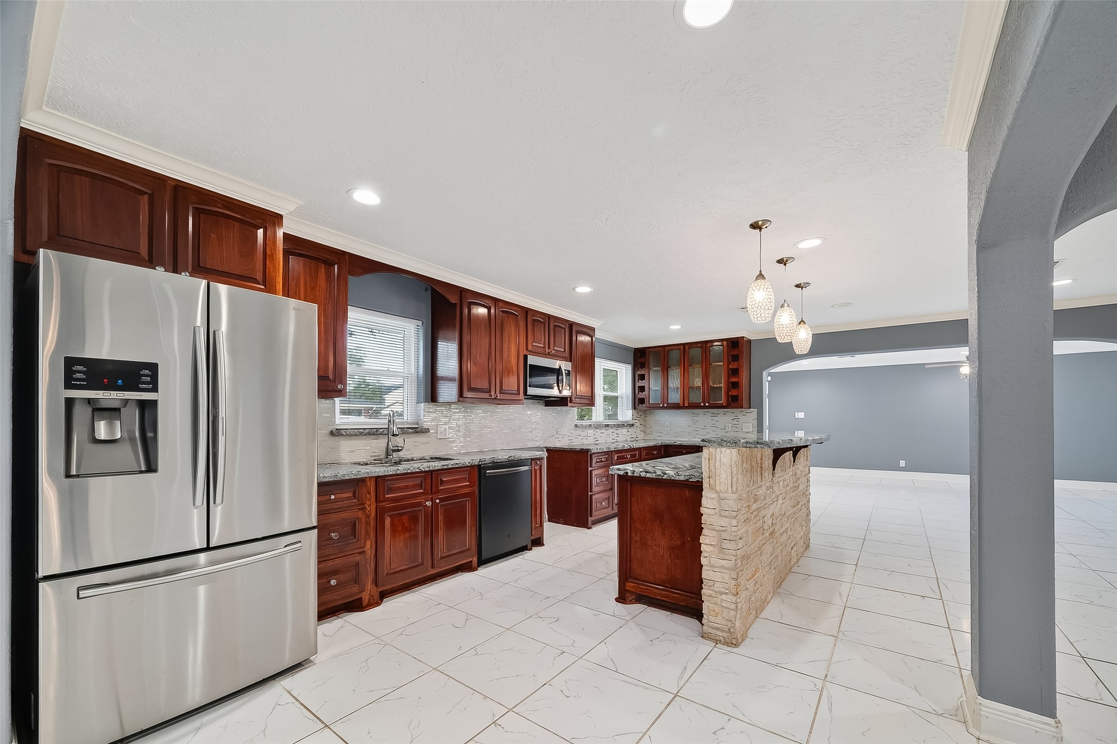 4901 Burning Tree Drive Baytown, TX 77521 - Photo 9 of 47 a kitchen with stainless steel appliances granite countertop a refrigerator and a sink