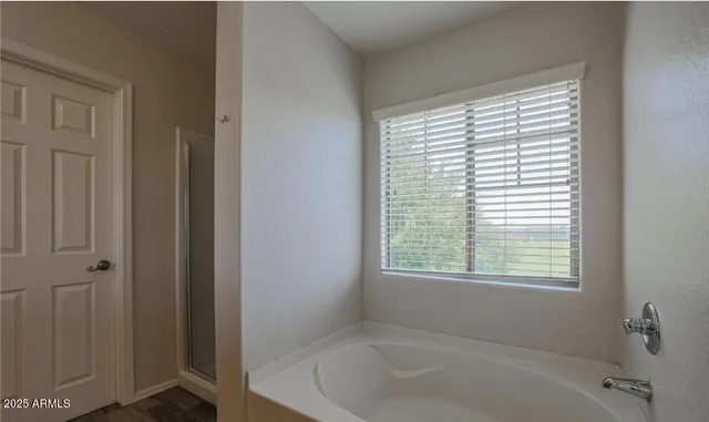 a white bath tub sitting next to a window