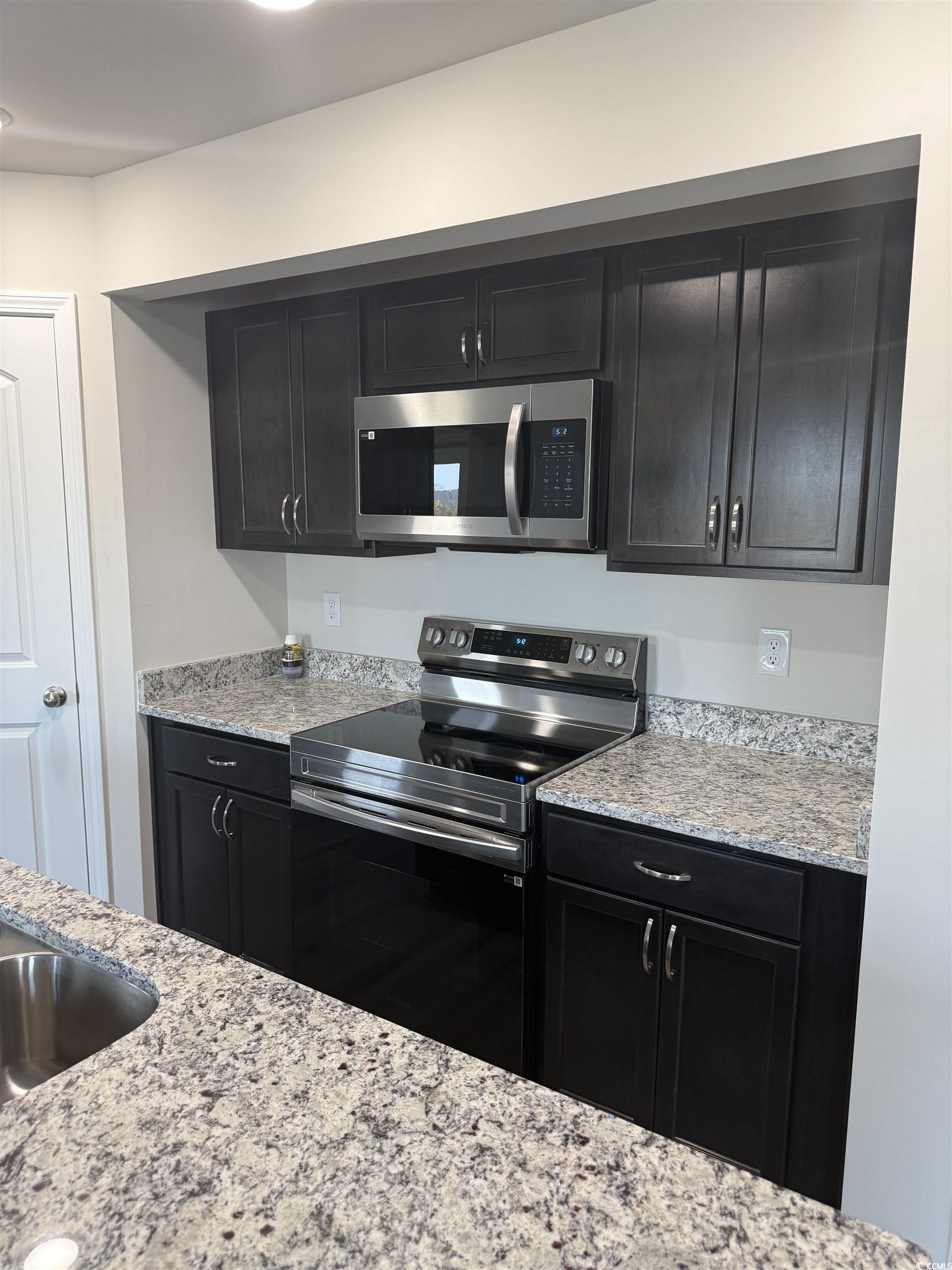 889 Busy Corner Road Conway, SC 29527 - Photo 5 of 25 Kitchen with light stone countertops, a sink, stai