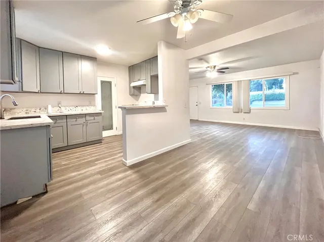 a kitchen with a sink cabinets and window