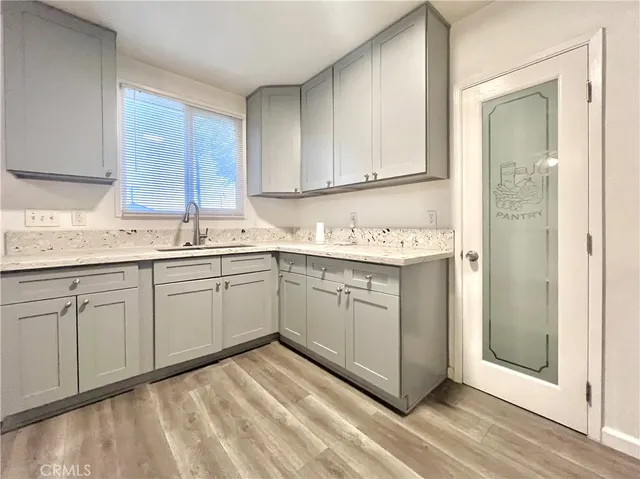 a kitchen with a sink cabinets and window