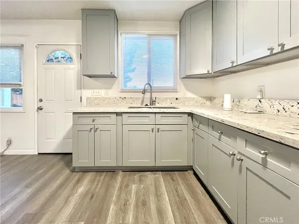 a kitchen with a sink cabinets and window