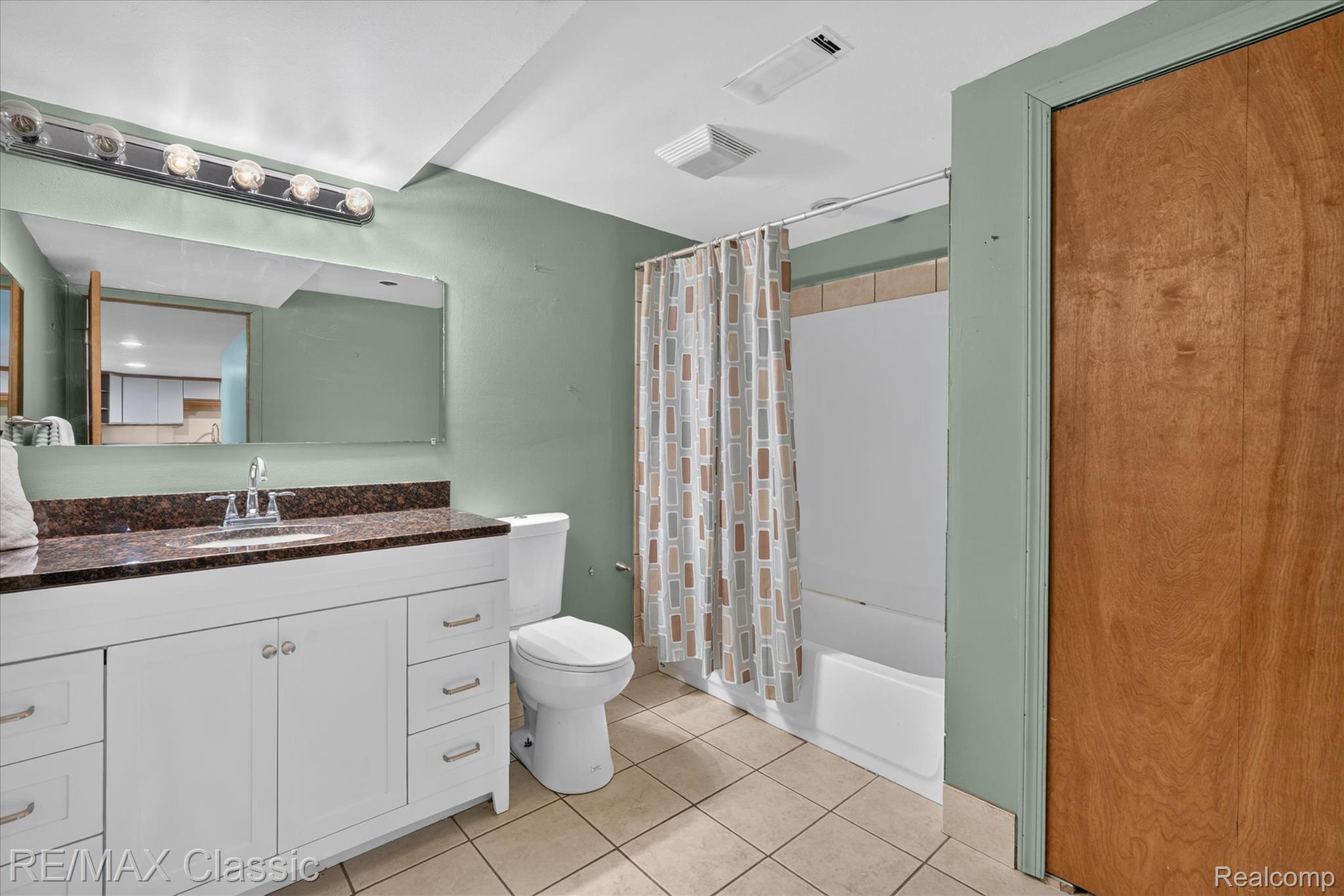 12189 Gage Road Holly, MI 48442 - Photo 46 of 69 Bathroom featuring a white vanity with a dark countertop, an integrated sink, and a chrome faucet