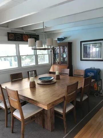 a view of a dining room with furniture and window