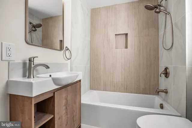 a bathroom with a sink vanity toilet and shower