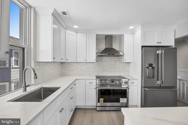 a kitchen with a sink stove and refrigerator