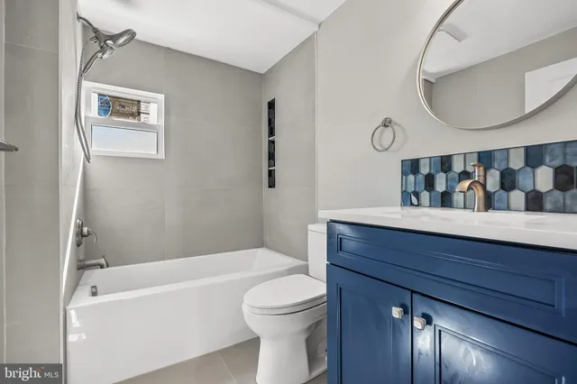 a bathroom with a toilet a sink and bathtub