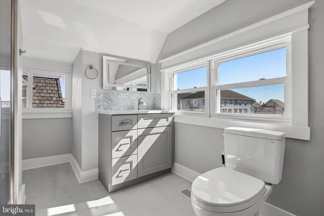 a bathroom with a toilet a sink and a mirror