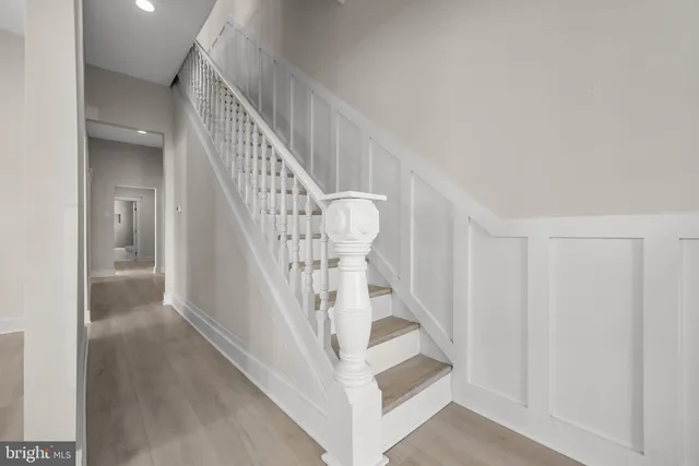 a view of entryway and hall with wooden floor