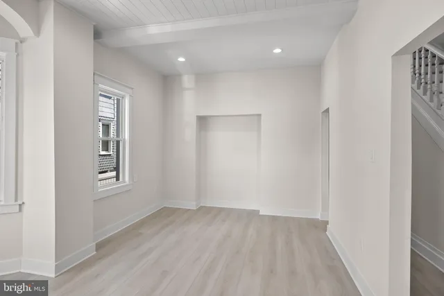 an empty room with windows and closet
