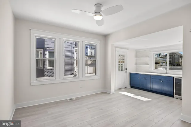 a view of an empty room with a kitchen