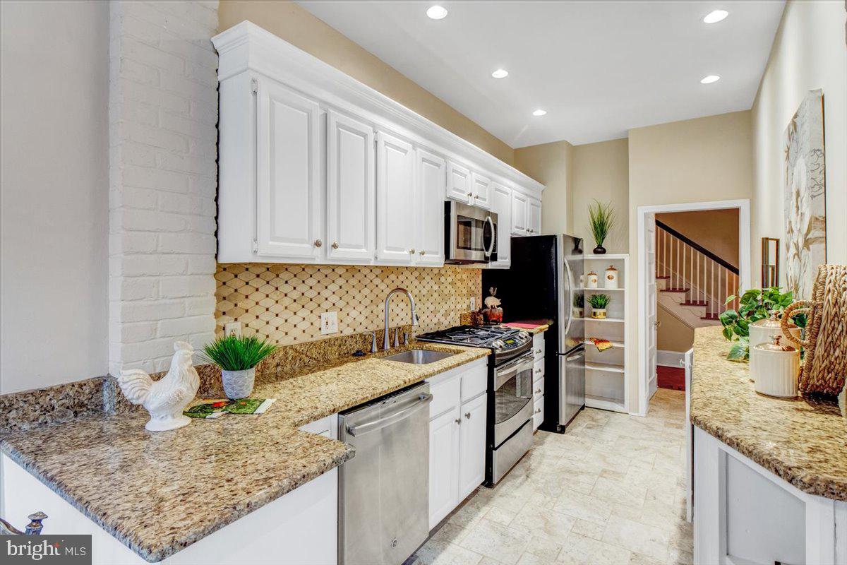 1133 Columbia Road Northwest Washington, DC 20009 - Photo 11 of 57 Granite counters and tiled backsplash
