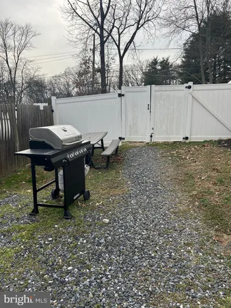a backyard of a house with table and chairs