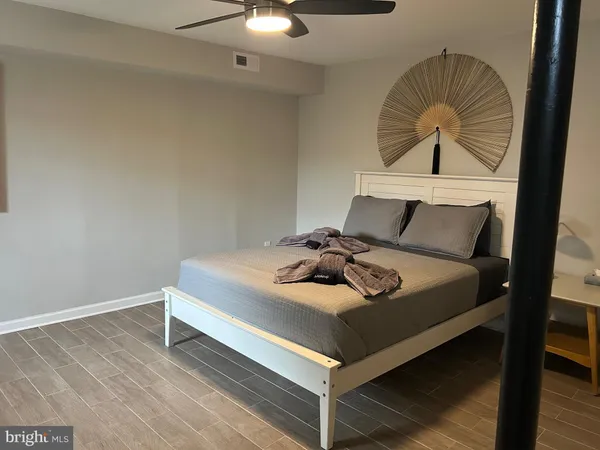 a living room with a bed furniture and a window