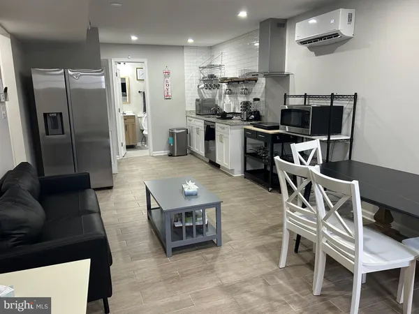 a kitchen with stainless steel appliances kitchen island granite countertop a refrigerator and a stove top oven