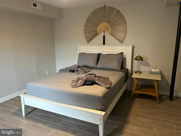 a bedroom with a bed and a mirror