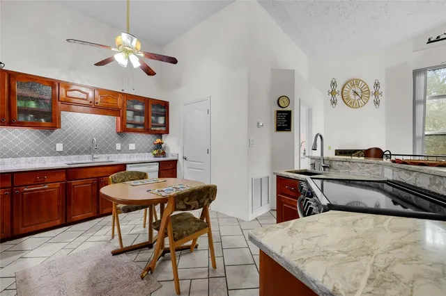 a kitchen with a table chairs and a refrigerator