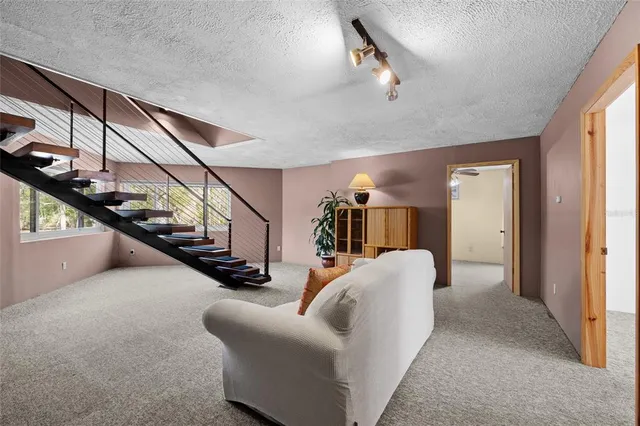 a hallway with stairs and a couch