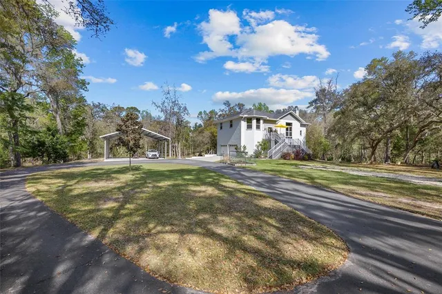 an aerial view of house with yard swimming pool and outdoor seating