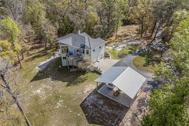 an aerial view of a house with a lake view