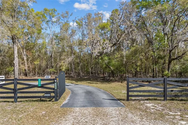 a view of a yard with wooden fence