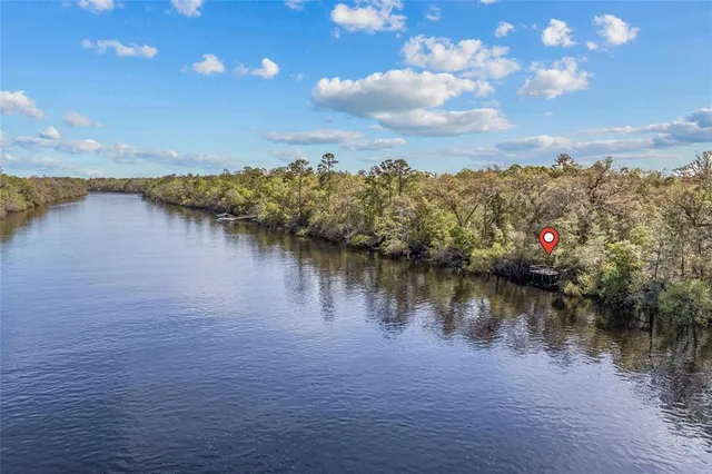 an aerial view of lake and residential houses with outdoor space