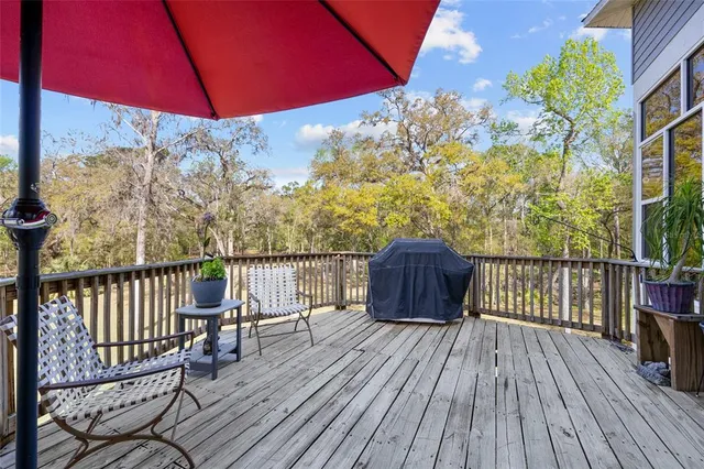 a view of a balcony with wooden floor and fence